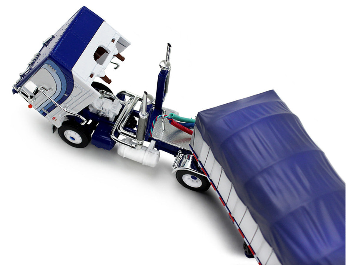 Peterbilt 352 COE 110" Sleeper and 53’ Wilson Roadbrute Flatbed Trailer with Covered Wagon White with Blue Stripes 1/64 Diecast Model by DCP/First Gear