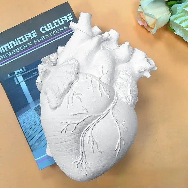 White anatomical heart vase with branches for living room decor