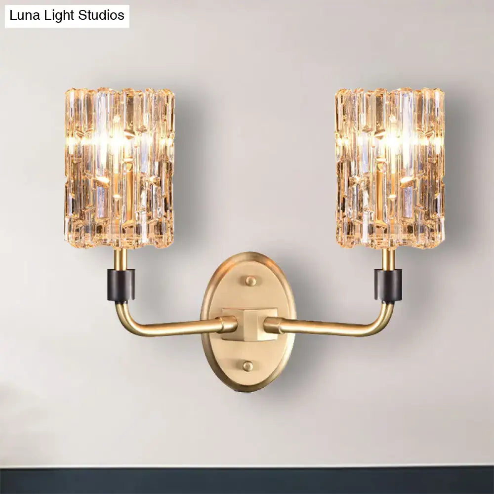 Contemporary brass bedside wall sconce with clear crystal shade bedroom