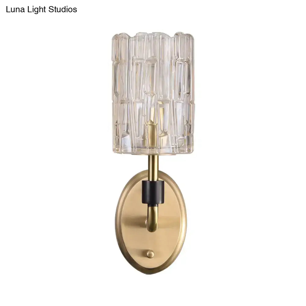 Contemporary brass bedside wall sconce with clear crystal shade bedroom