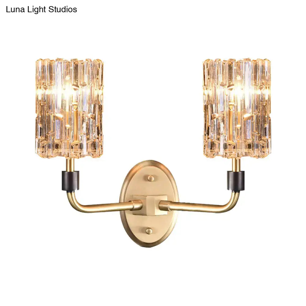 Contemporary brass bedside wall sconce with clear crystal shade bedroom