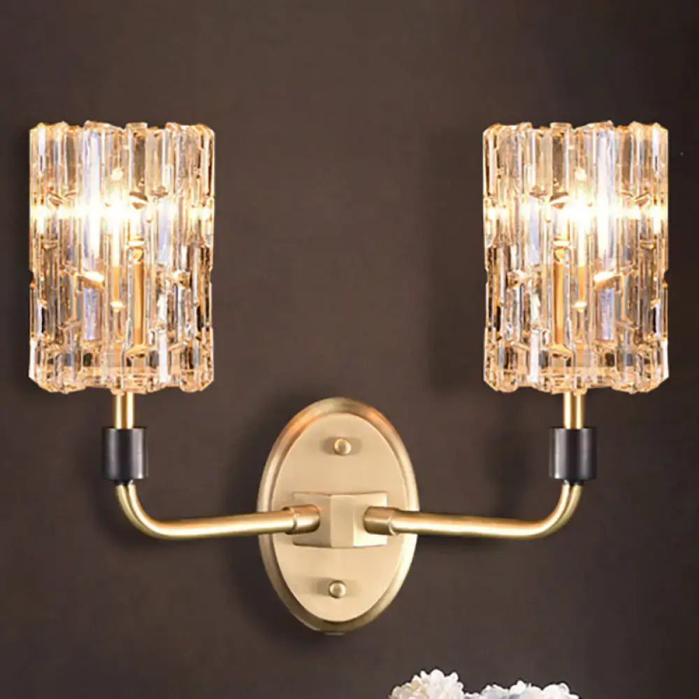 Contemporary brass bedside wall sconce with clear crystal shade bedroom