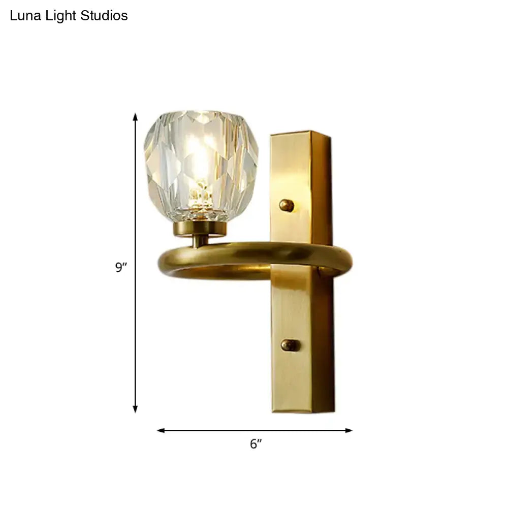 Contemporary brass wall sconce with global crystal shade dining room