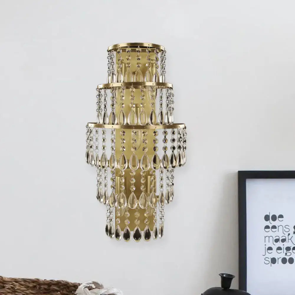 Contemporary gold layered bedside wall lamp with teardrop crystals