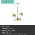 Modern amber glass chandelier with brass accents for living room