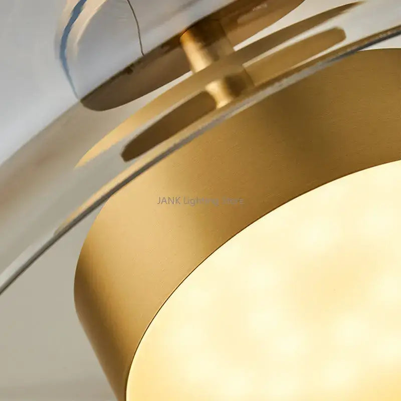 Modern amber glass chandelier with brass accents for living room