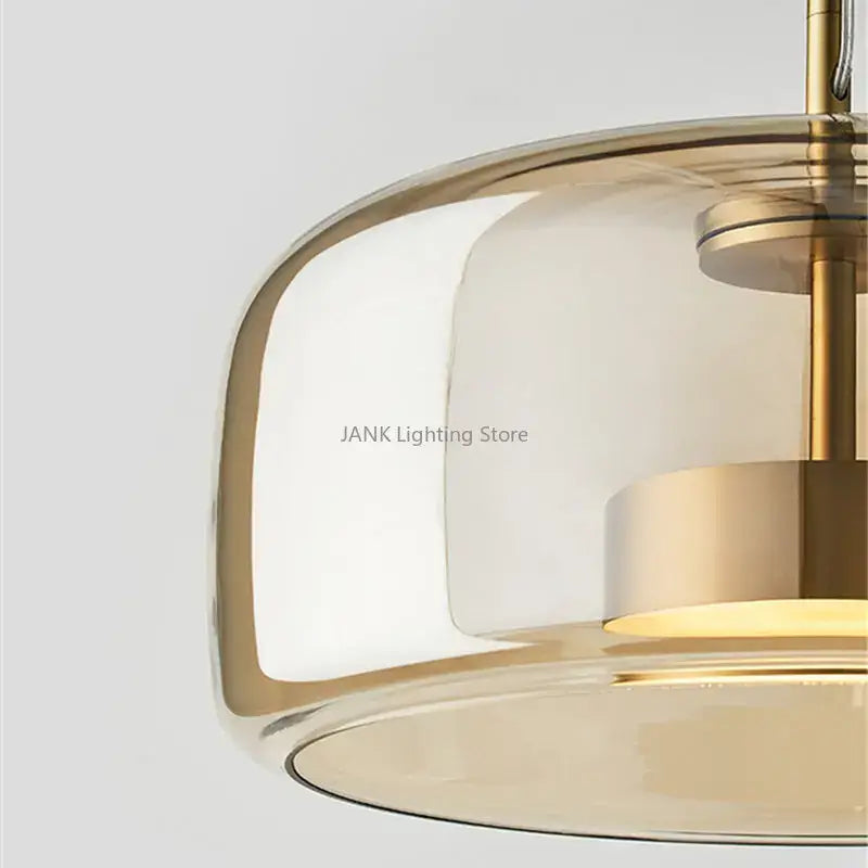 Modern amber glass chandelier with brass accents for living room