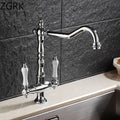 Antique brass kitchen faucet with ceramic handles and curved spout