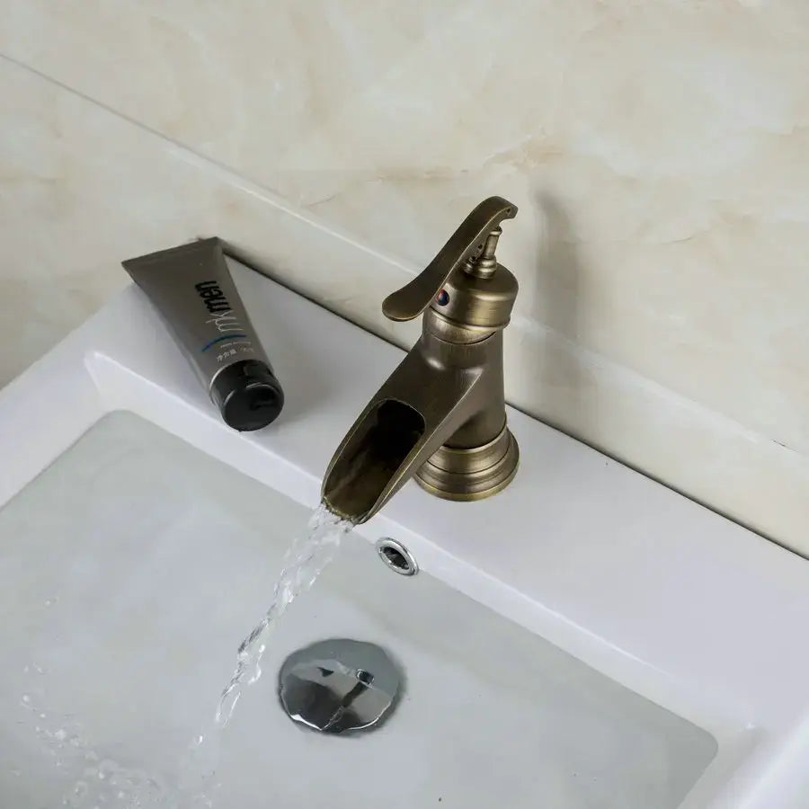 Antique brass waterfall basin faucet with art handle for bathroom