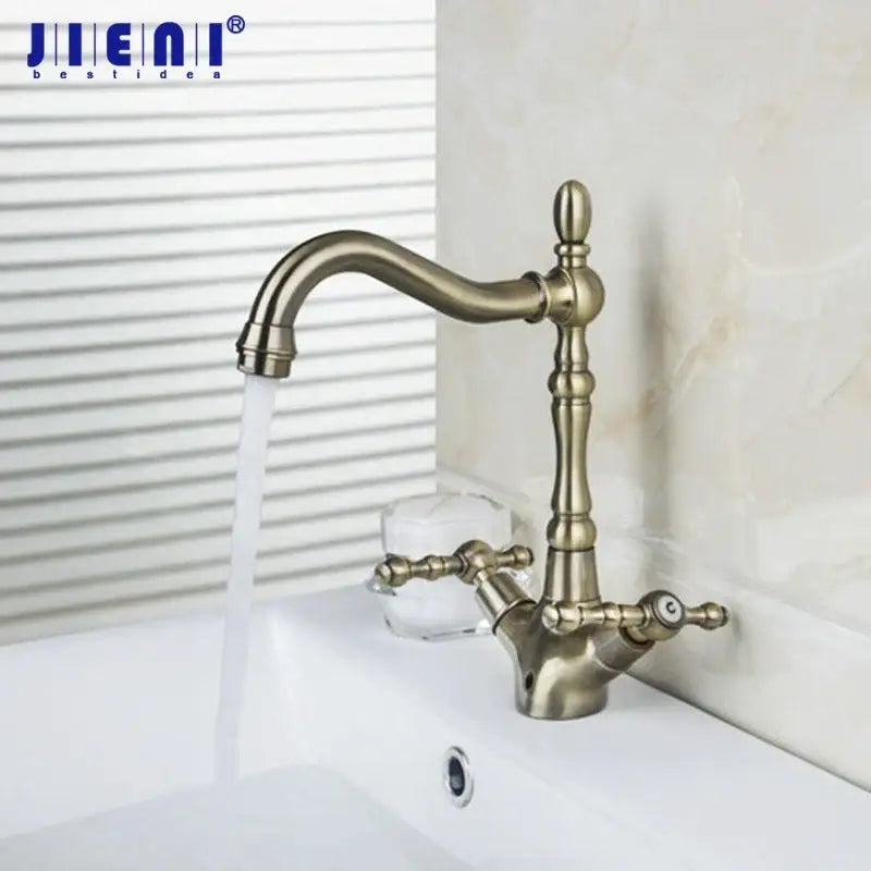 Antique brass kitchen swivel faucet with ornate two handles
