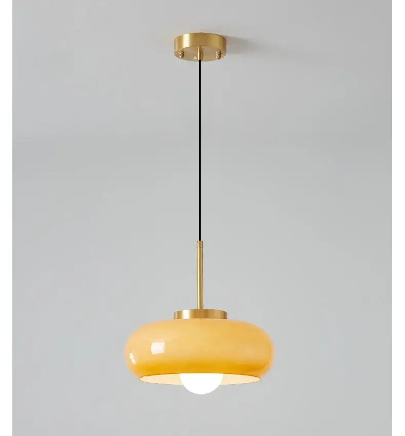 Sleek amber glass and copper pendant light for kitchens
