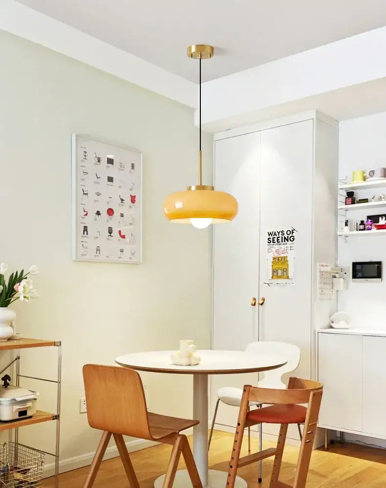 Sleek amber glass and copper pendant light for kitchens