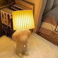Whimsical beige and yellow naughty boy table lamp for bedroom bedside