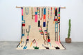 Beige moroccan azilal rug with vibrant geometric patterns bedroom decor