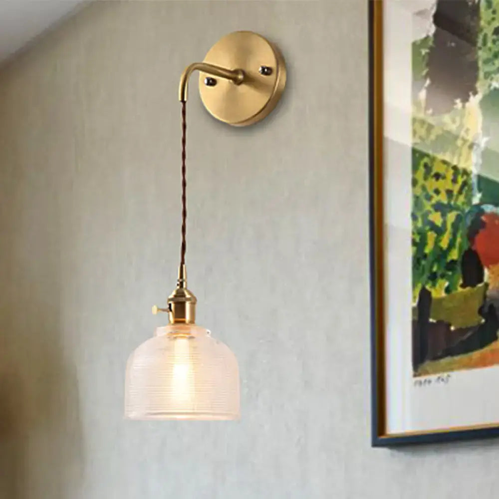 Industrial brass sconce with textured glass dome – bedroom light
