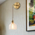 Industrial brass sconce with textured glass dome – bedroom light