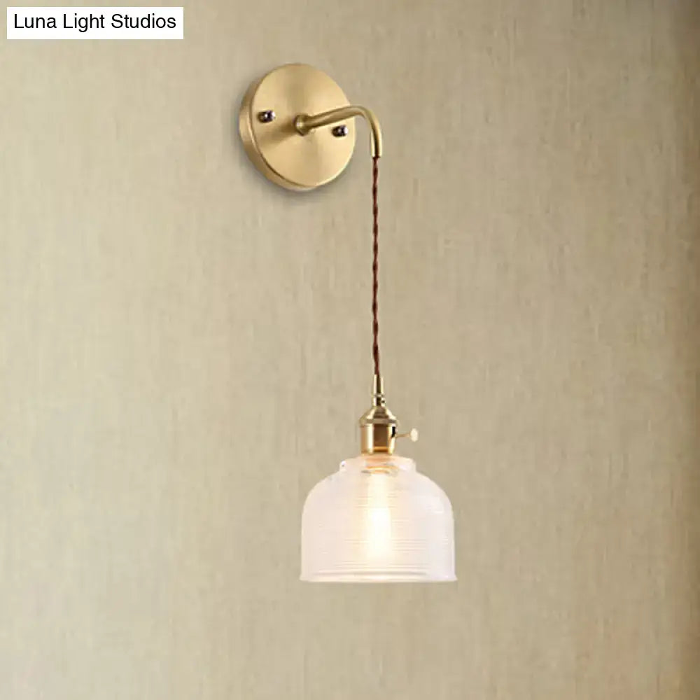 Industrial brass sconce with textured glass dome – bedroom light