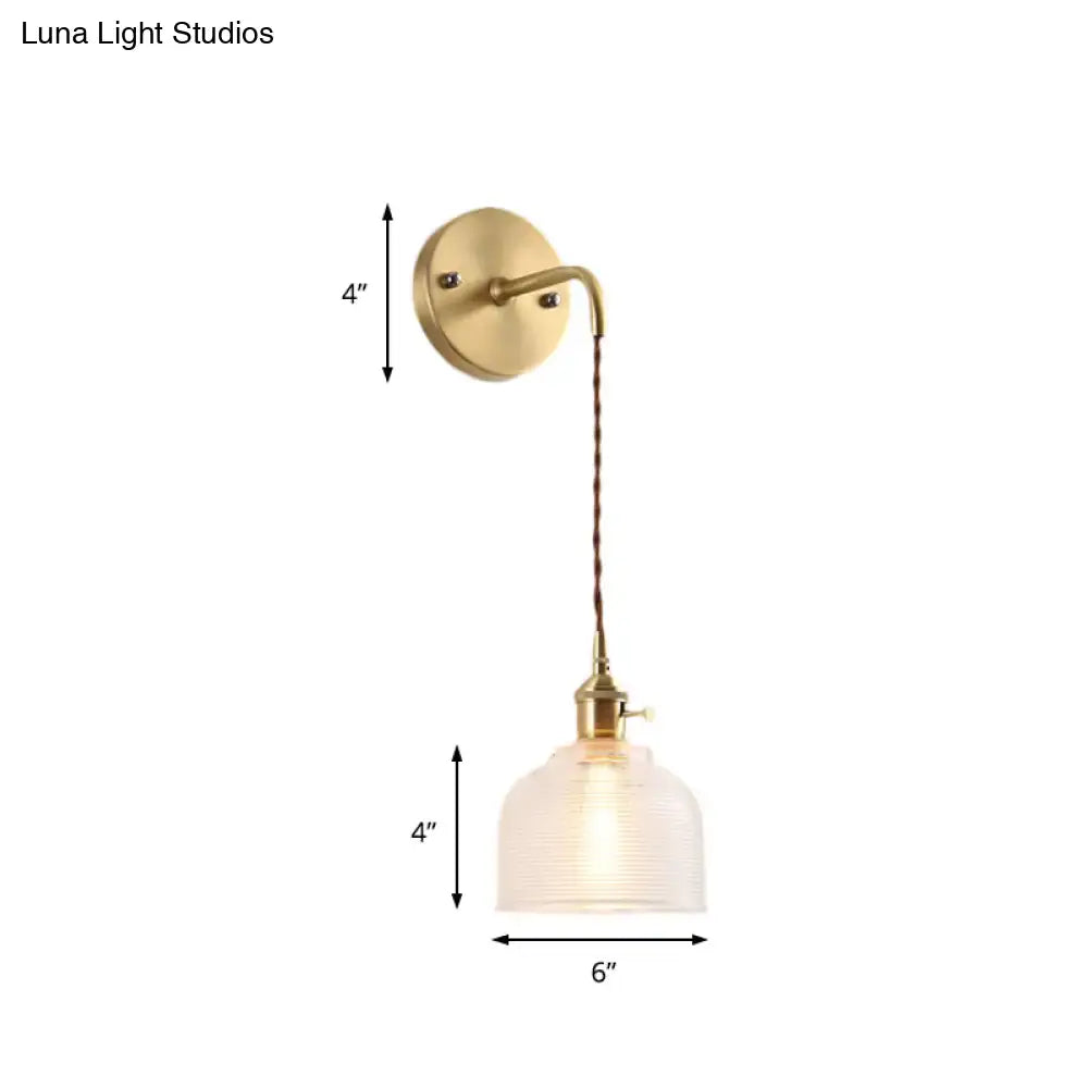 Industrial brass sconce with textured glass dome – bedroom light