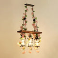 Rustic industrial cage island light with pink flowers dining room