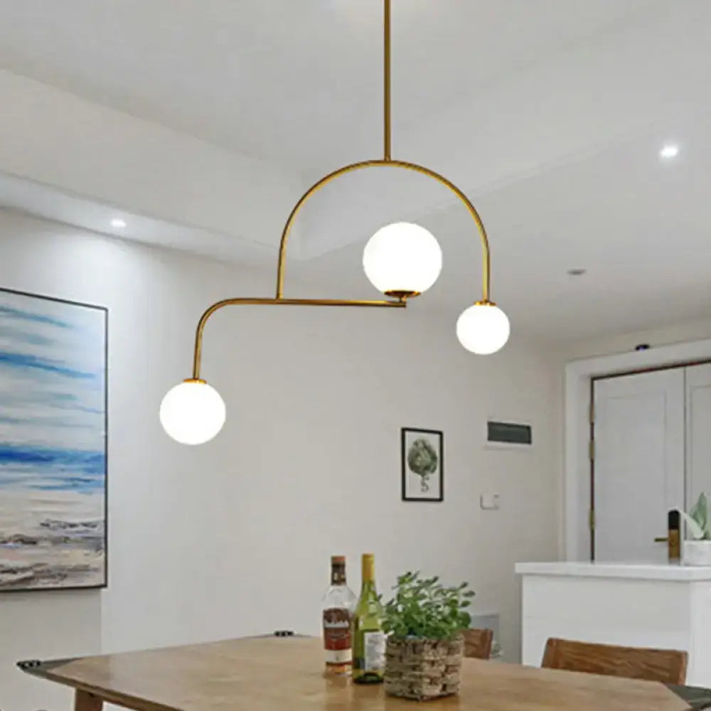 Modern gold global bedroom pendant light with white frosted glass