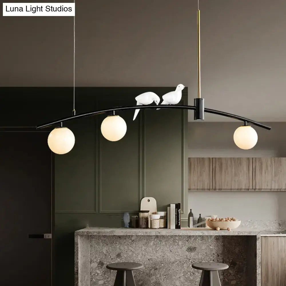 Modern black & brass pendant light with milk glass bird decoration