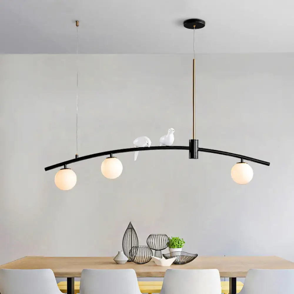 Modern black & brass pendant light with milk glass bird decoration