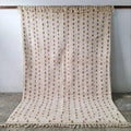 Handmade beige beni ouarain rug with pink accents for living room