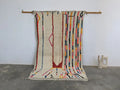 Moroccan handmade beige wool rug with colorful stripes living room