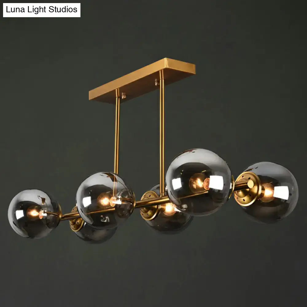 Postmodern gold kitchen island light with globe glass shade