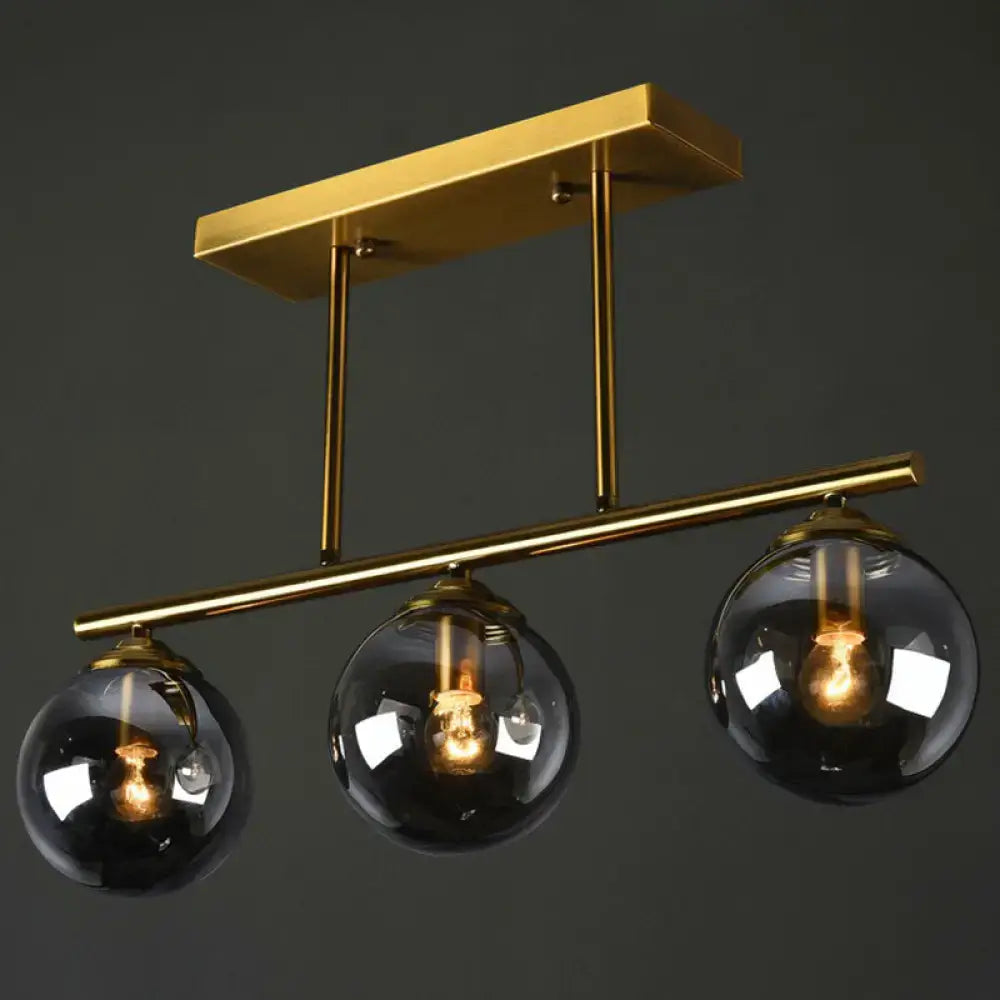 Postmodern gold kitchen island light with globe glass shade
