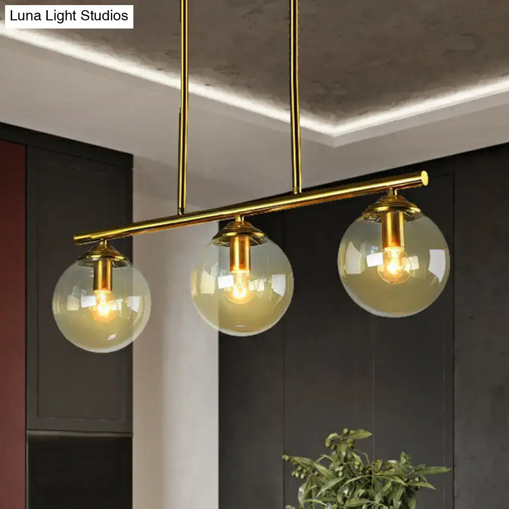 Postmodern gold kitchen island light with globe glass shade