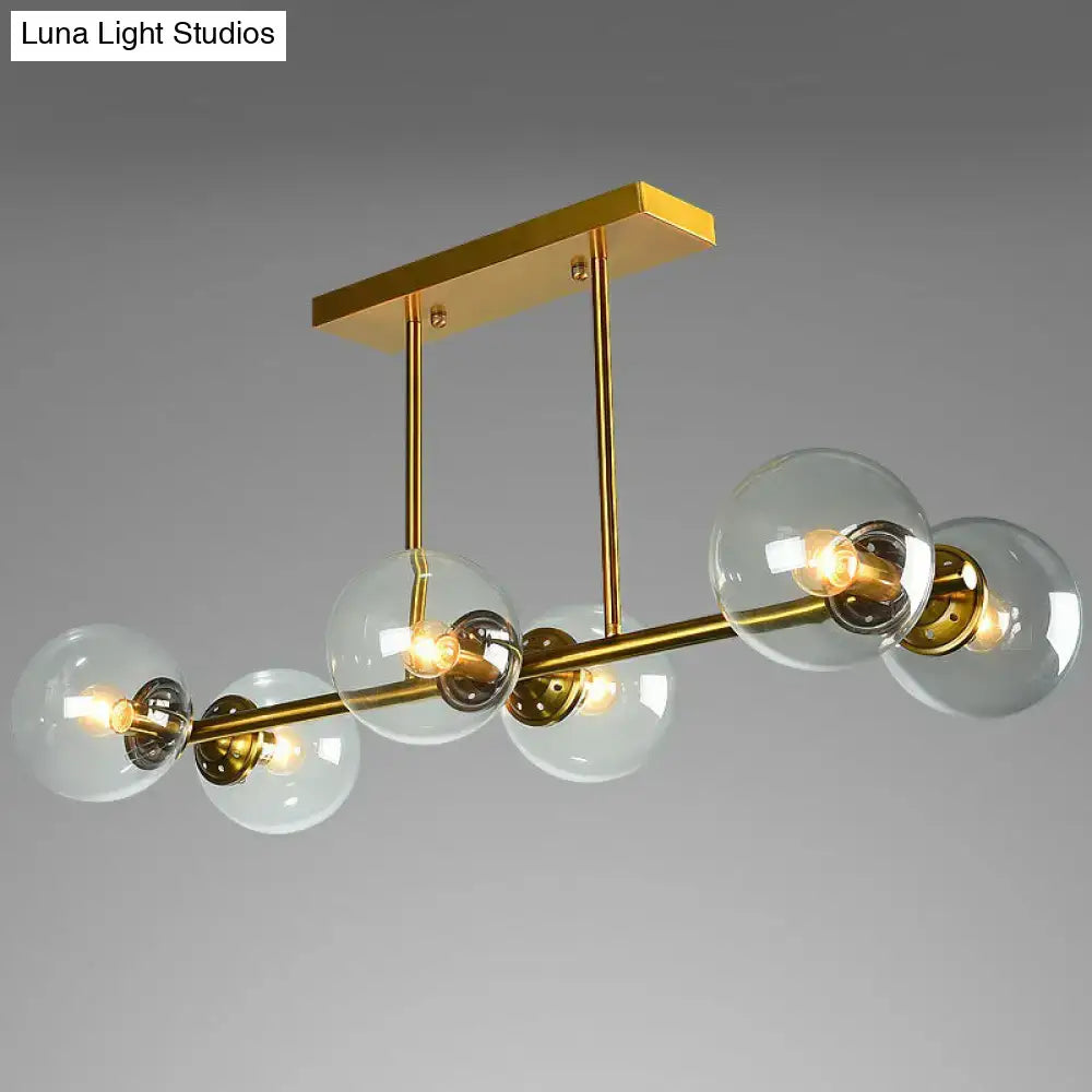 Postmodern gold kitchen island light with globe glass shade