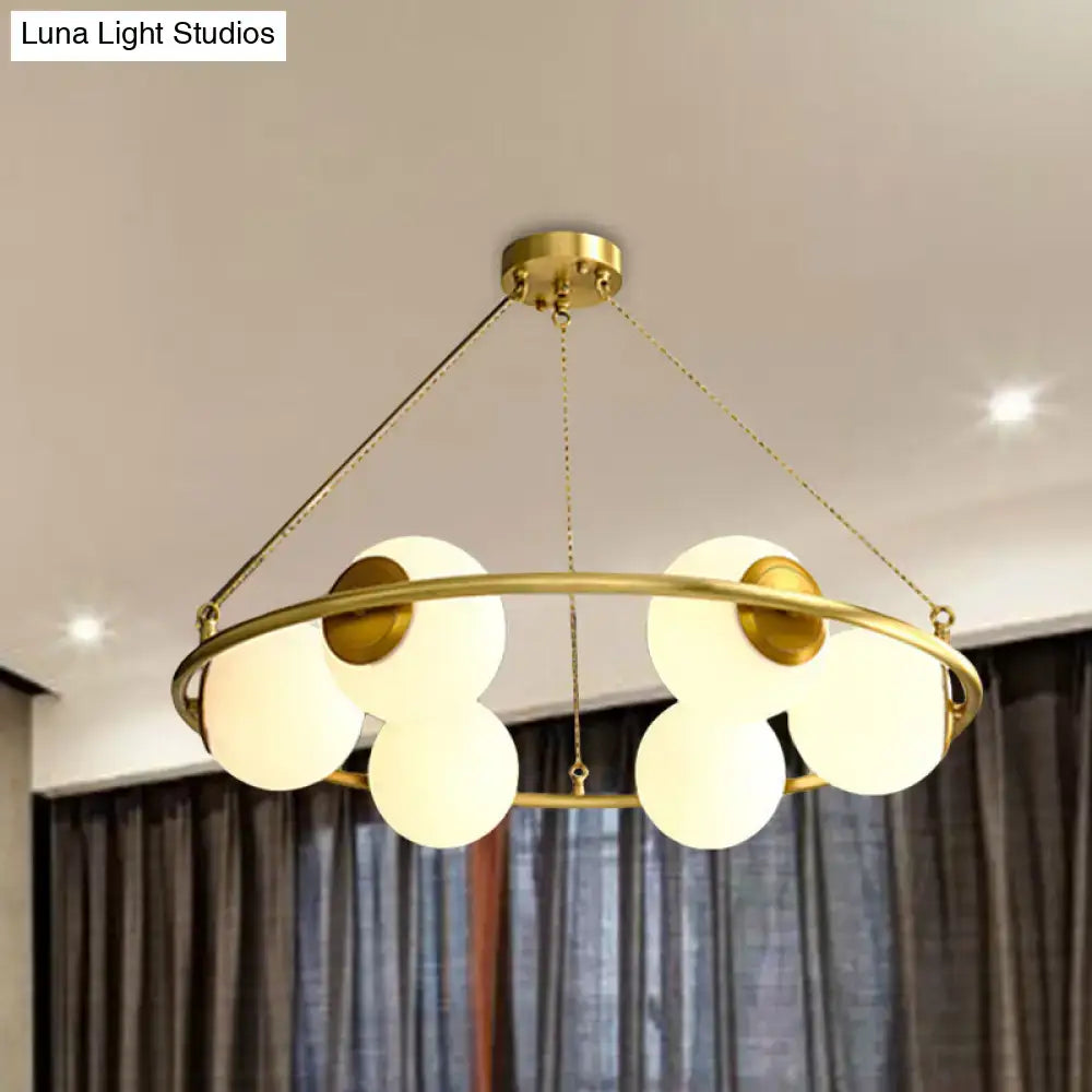 Postmodern brass circular chandelier with frosted glass dining room