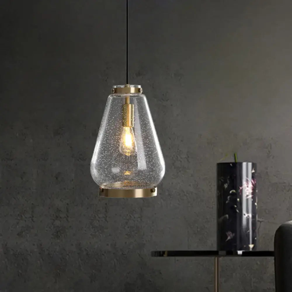 Modern seeded glass pendant light with brass rim bedroom