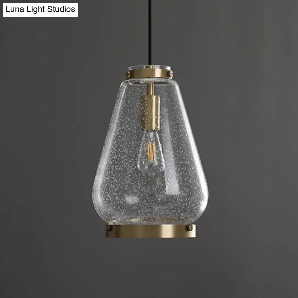Modern seeded glass pendant light with brass rim bedroom