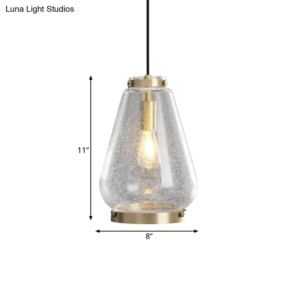 Modern seeded glass pendant light with brass rim bedroom