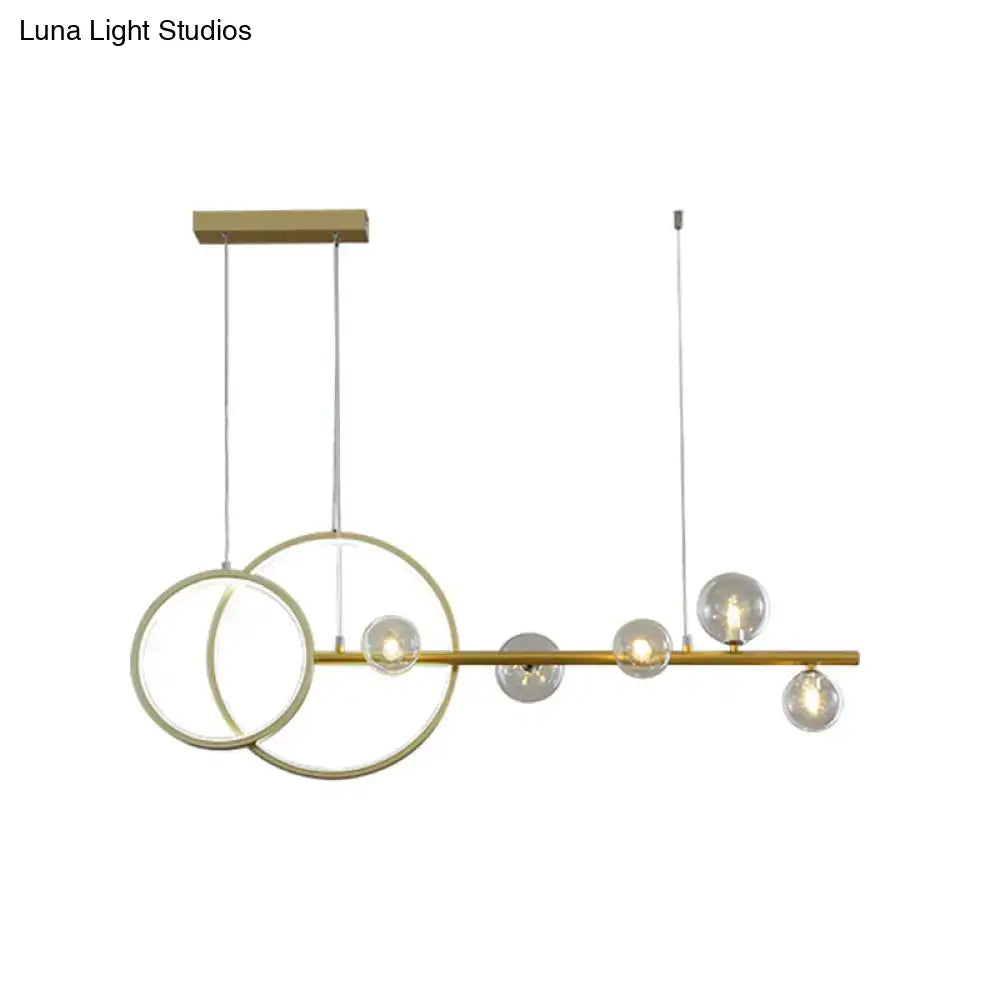 Modern gold ring ceiling light with clear glass sphere dining room