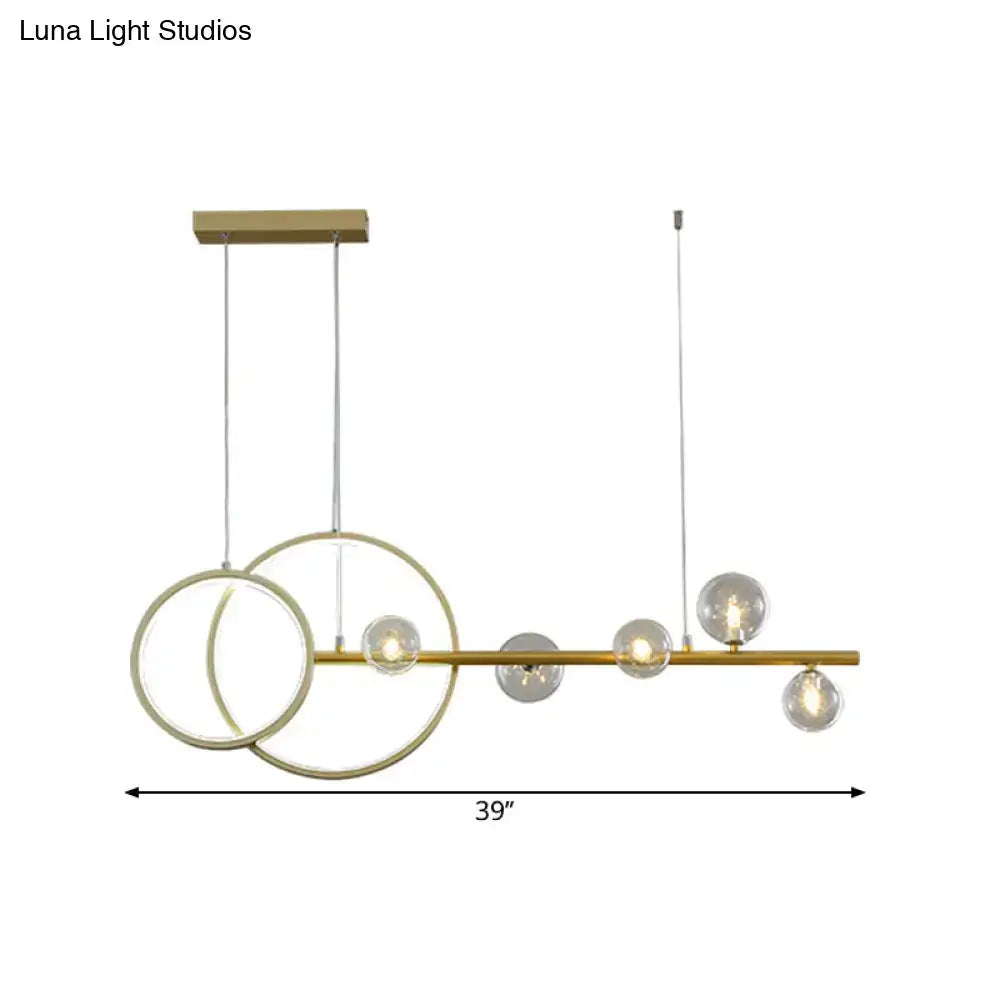 Modern gold ring ceiling light with clear glass sphere dining room