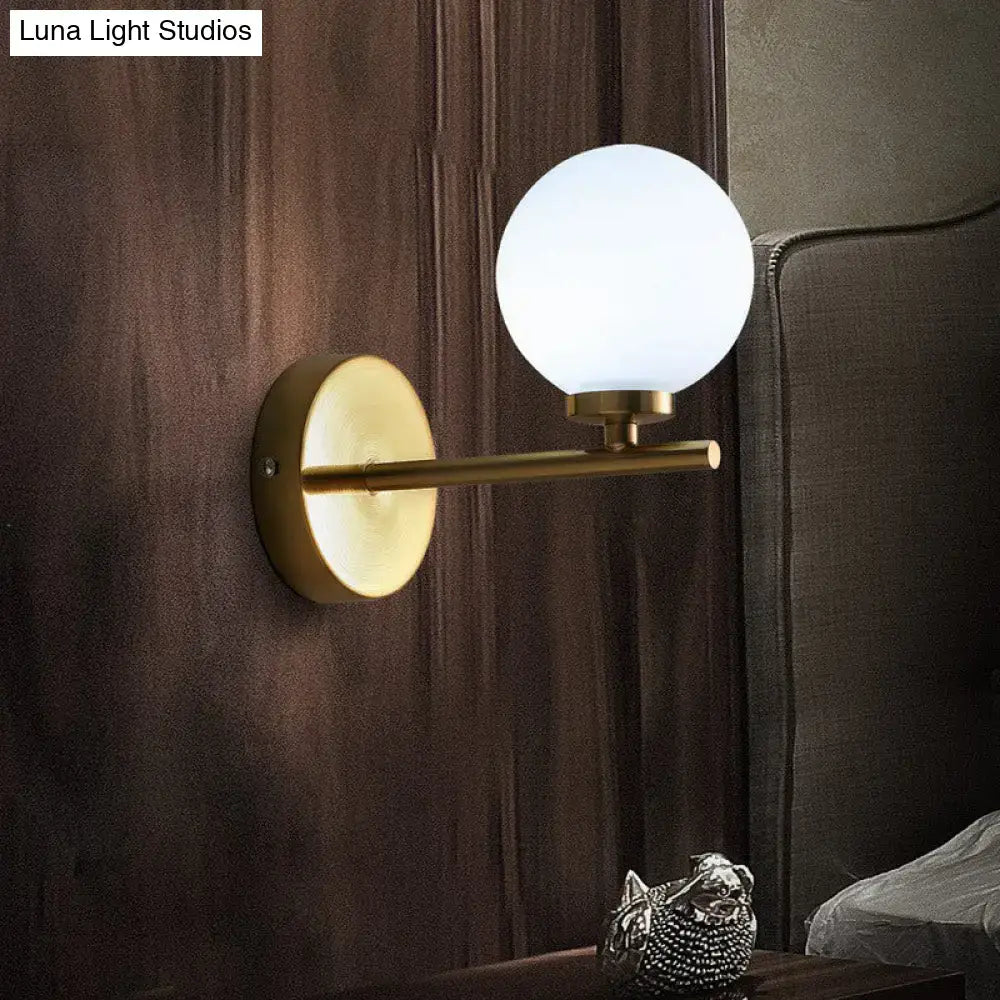 Elegant gold and ivory glass wall sconce for bedroom light