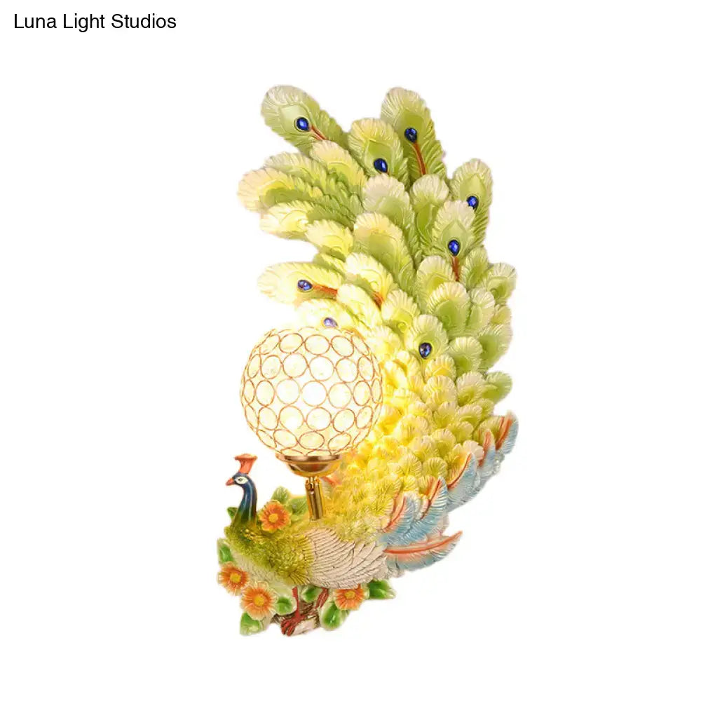 Golden peacock wall light with crystal shade – living room yellow & green