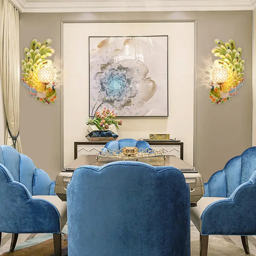 Golden peacock wall light with crystal shade – living room yellow & green