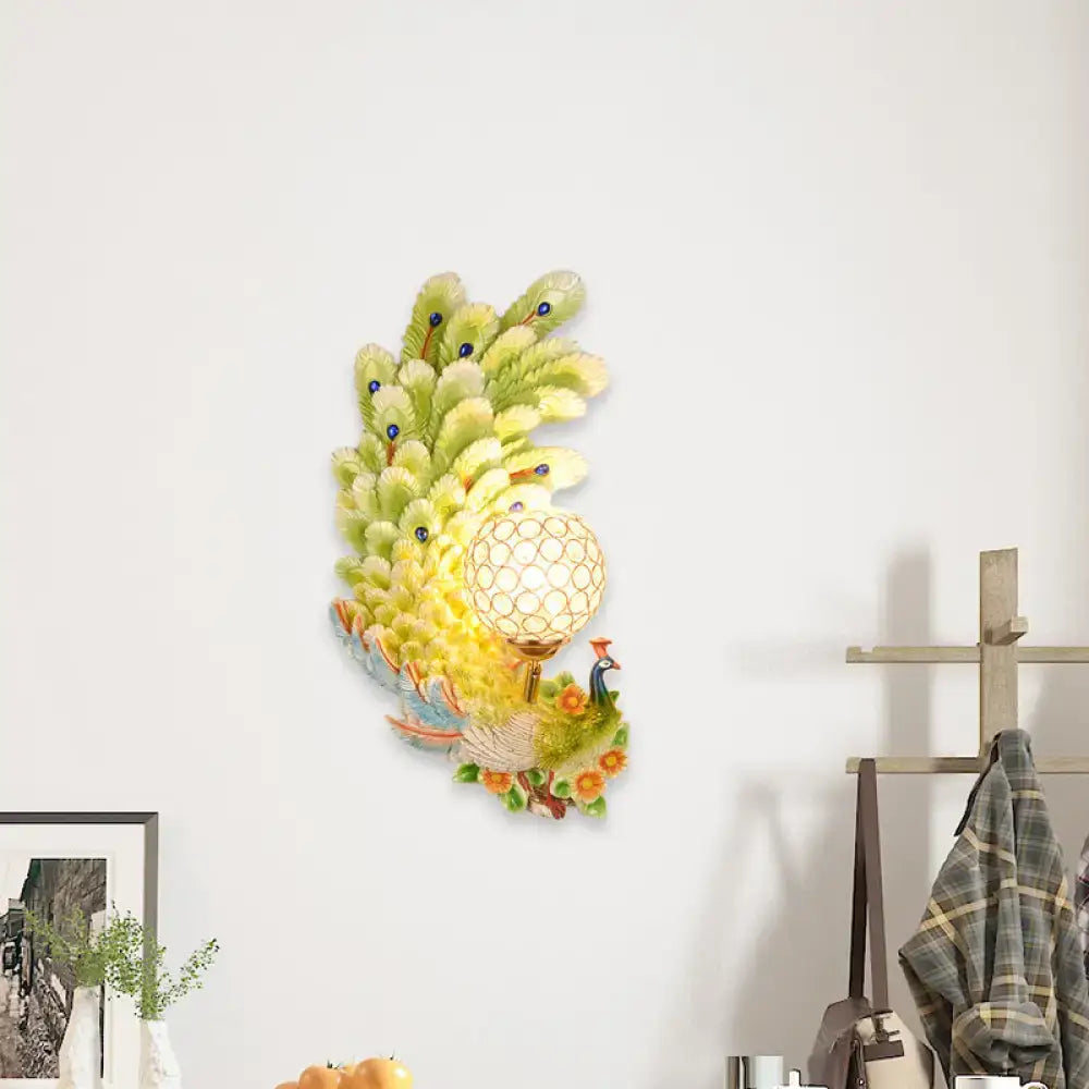 Golden peacock wall light with crystal shade – living room yellow & green