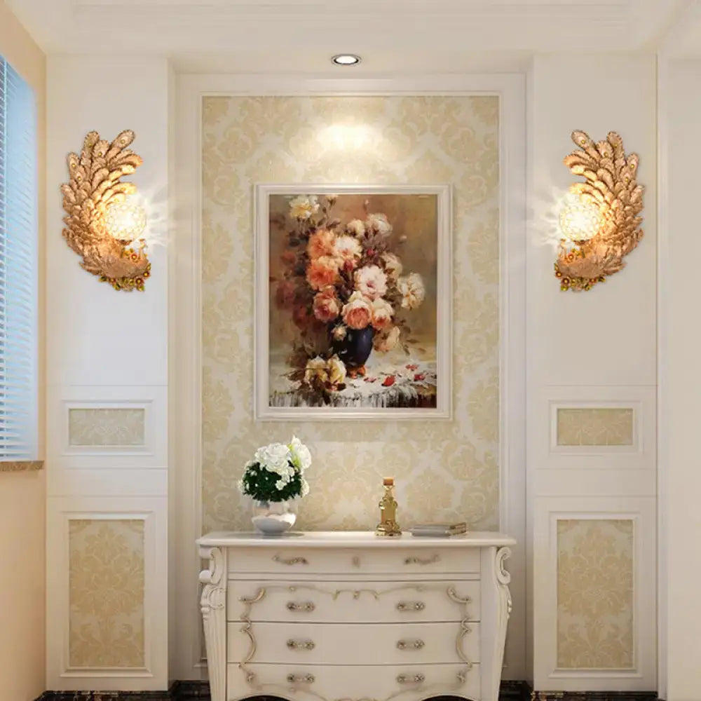 Golden peacock wall light with crystal shade – living room yellow & green