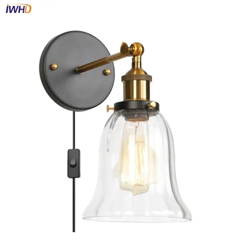 Industrial brass and clear glass wall sconce for bedroom