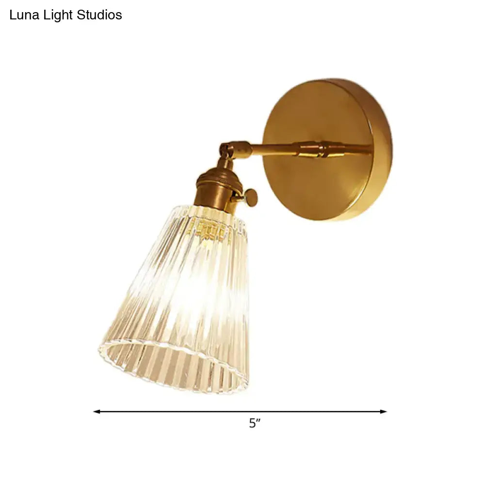 Industrial brass and clear textured glass wall sconce dining room