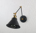 Matte black umbrella wall lights with brass accents – living room