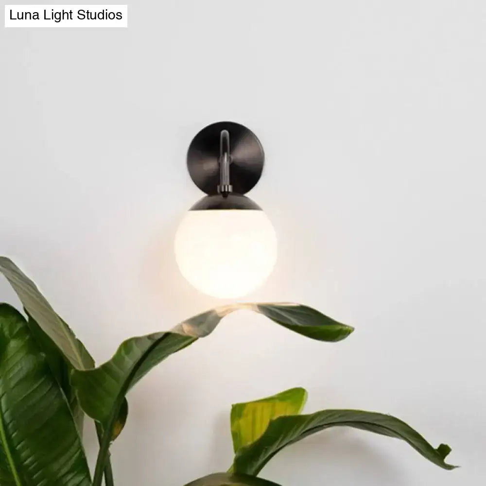 Minimalist black & gold wall light with milky glass ball for bedroom