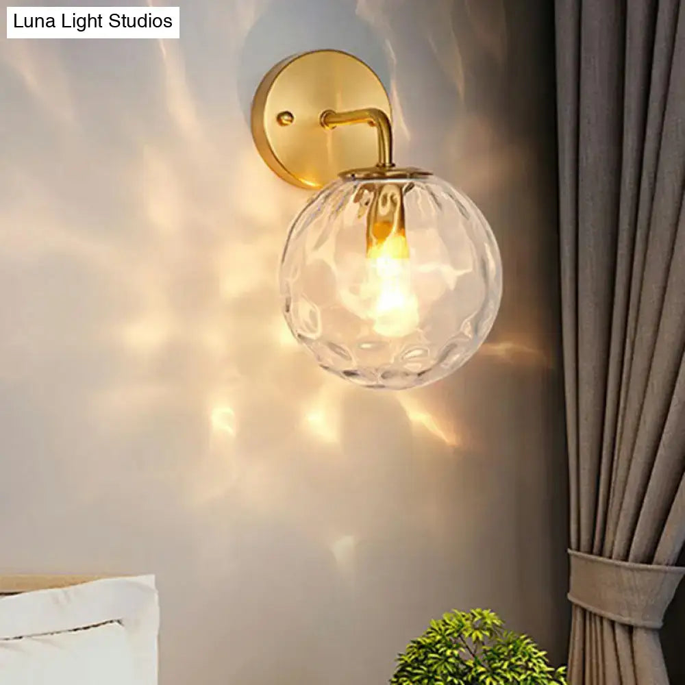 Minimalist gold ball sconce with hammered glass shade bedroom light
