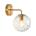 Minimalist gold ball sconce with hammered glass shade bedroom light
