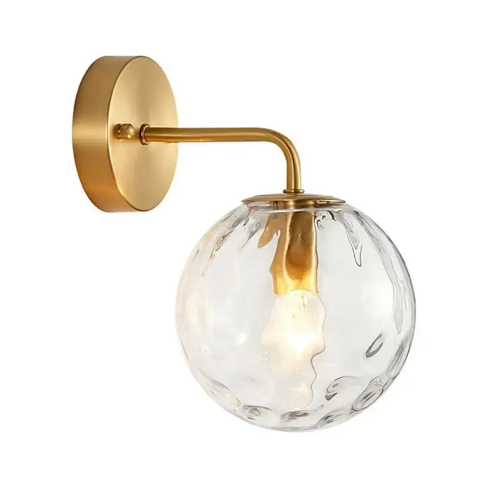 Minimalist gold ball sconce with hammered glass shade bedroom light
